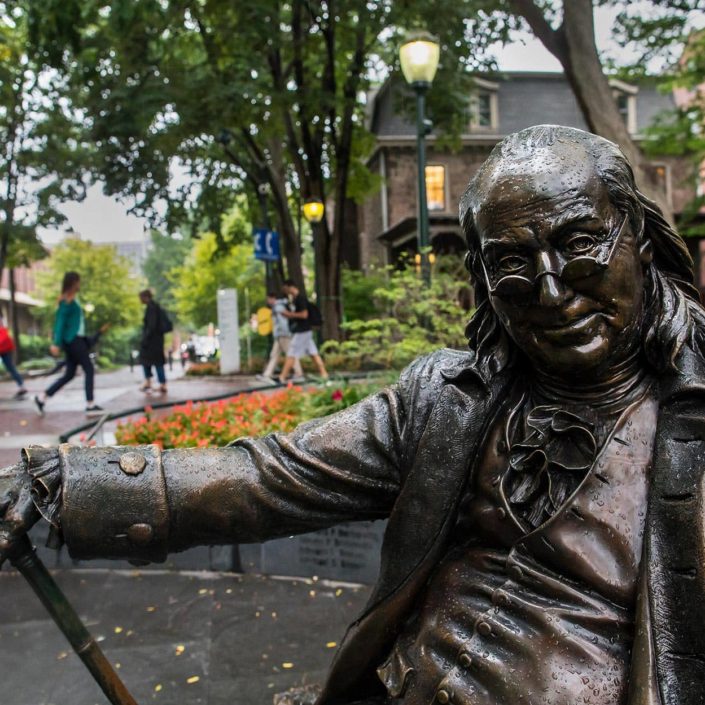 Ben Franklin statue sitting on bench along Penn's campus